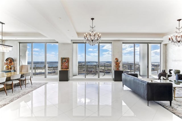 living area with light tile patterned flooring, a raised ceiling, and a notable chandelier