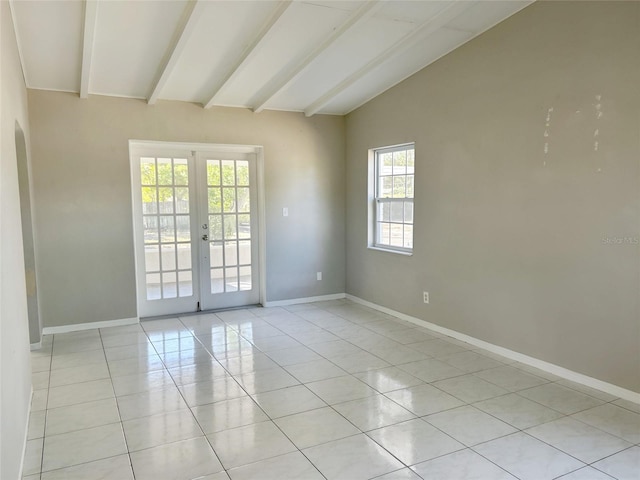 unfurnished room featuring vaulted ceiling with beams, arched walkways, light tile patterned flooring, baseboards, and french doors