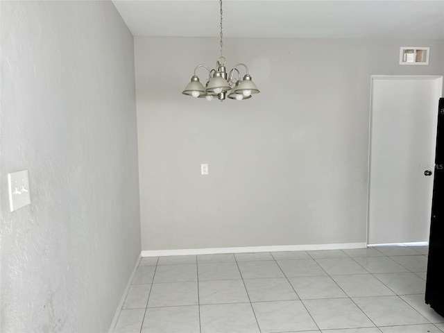 unfurnished dining area featuring an inviting chandelier, baseboards, and visible vents