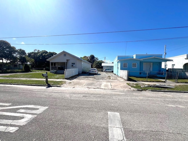 view of front of home featuring fence