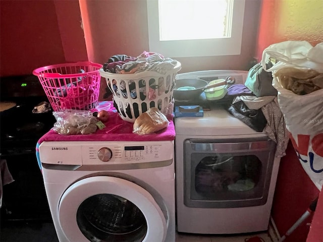 laundry room with washing machine and clothes dryer and laundry area