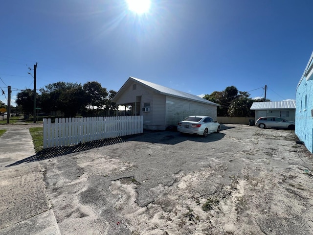 view of home's exterior with fence