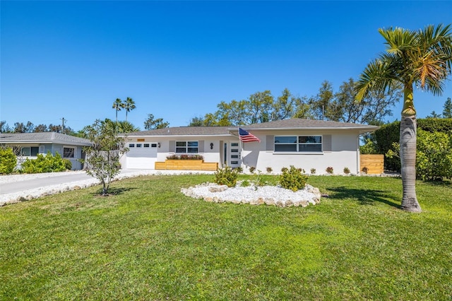 ranch-style home with a front yard, driveway, an attached garage, and stucco siding