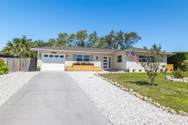 ranch-style home with a garage, fence, concrete driveway, stucco siding, and a front lawn