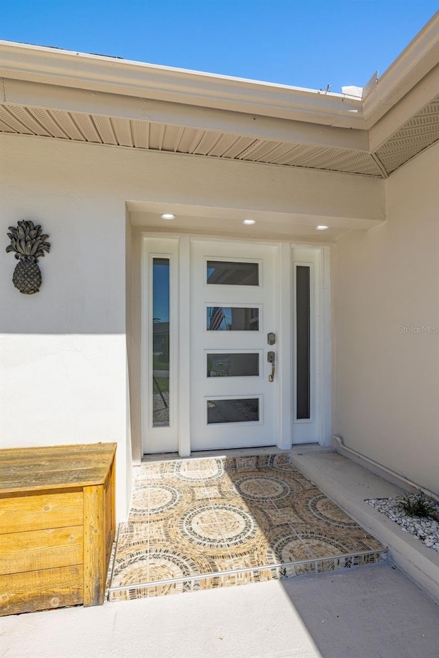 doorway to property with stucco siding