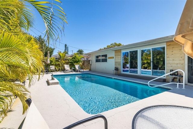 view of swimming pool with a patio area, fence, and a fenced in pool