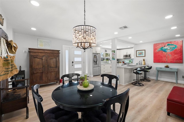 dining room with recessed lighting, visible vents, an inviting chandelier, light wood-type flooring, and baseboards