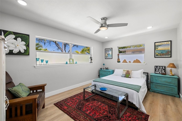 bedroom with light wood-style flooring, multiple windows, baseboards, and recessed lighting