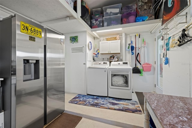 laundry area with cabinet space and washing machine and clothes dryer