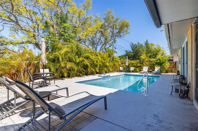 view of swimming pool with a patio, fence, and a fenced in pool