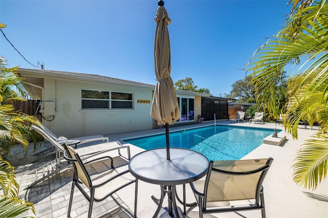 view of swimming pool featuring a patio, fence, and a fenced in pool