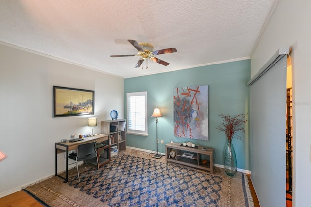 office space featuring baseboards, a textured ceiling, a ceiling fan, and crown molding