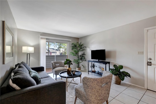 living area featuring light tile patterned flooring and baseboards