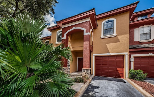 view of front of home with an attached garage and stucco siding