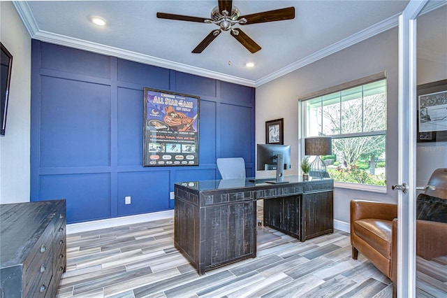 home office with ceiling fan, light wood-style flooring, a decorative wall, and crown molding