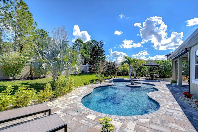 view of swimming pool with a lawn, a patio area, and a fenced backyard