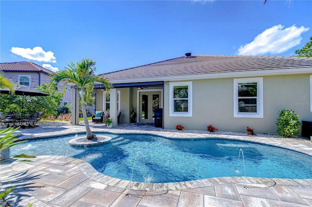 pool featuring a ceiling fan, french doors, and a patio area