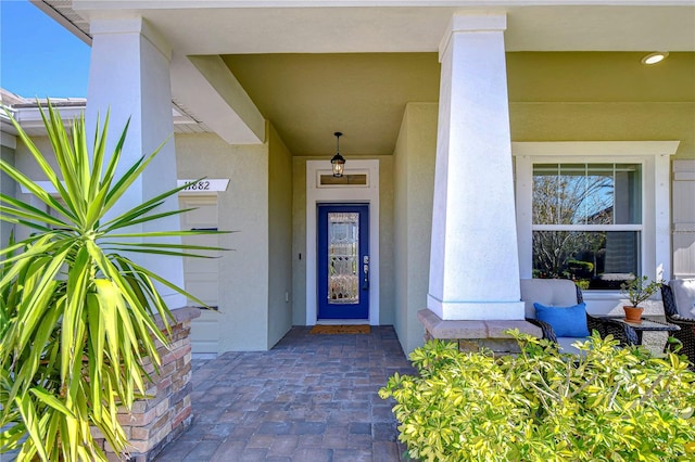 view of exterior entry featuring stucco siding