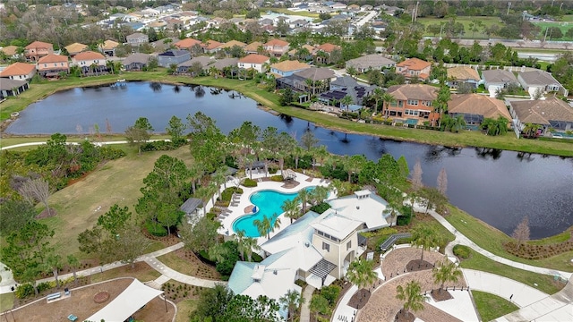 drone / aerial view featuring a water view and a residential view