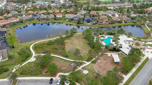 drone / aerial view featuring a residential view and a water view