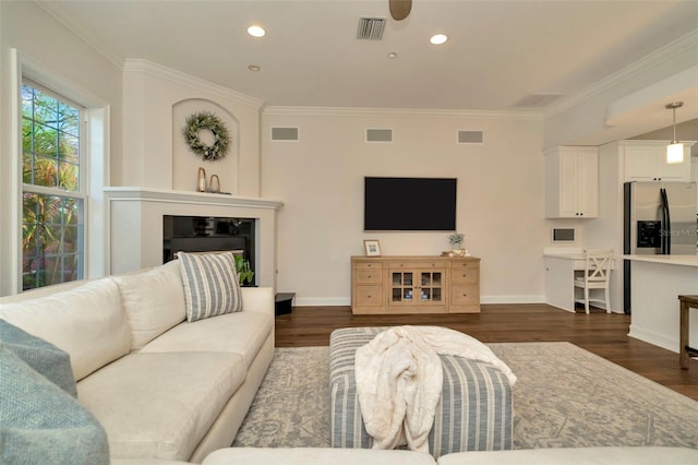 living area with recessed lighting, visible vents, dark wood-style flooring, and ornamental molding