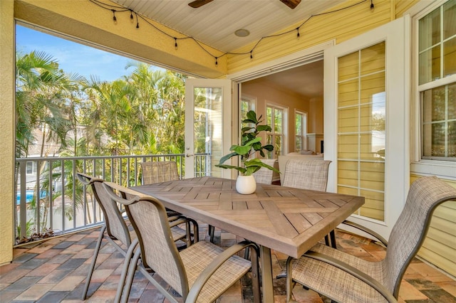 sunroom featuring a ceiling fan