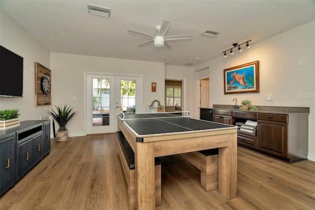 recreation room with visible vents, french doors, and light wood-style flooring