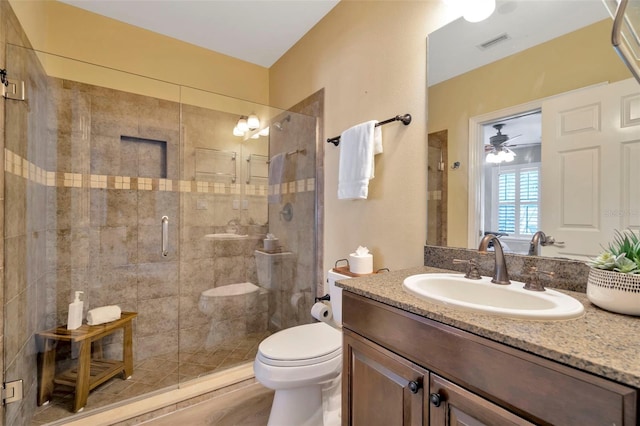 full bathroom featuring toilet, a shower stall, visible vents, and vanity