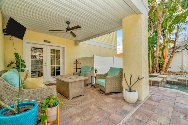 view of patio / terrace featuring french doors, fence, and ceiling fan