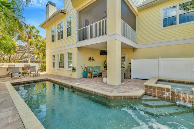 back of property featuring a patio, a chimney, fence, and stucco siding