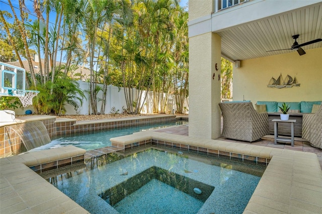 view of pool with a fenced backyard, ceiling fan, and an in ground hot tub