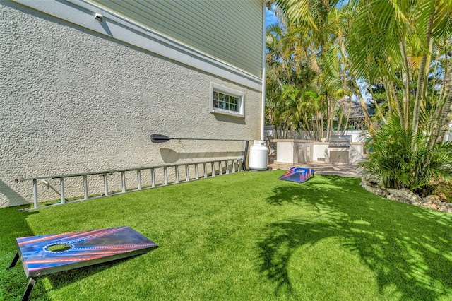 view of yard featuring fence and area for grilling