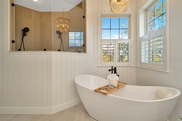 bathroom featuring a freestanding bath and a walk in shower