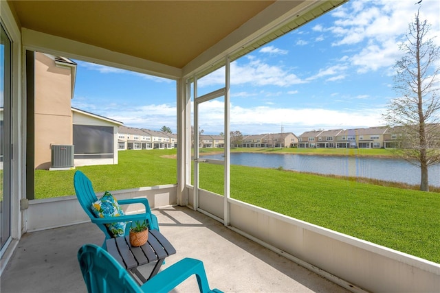 unfurnished sunroom featuring a residential view and a water view