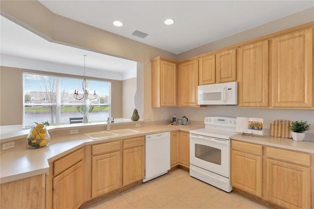 kitchen with light brown cabinets, a sink, white appliances, a peninsula, and a chandelier