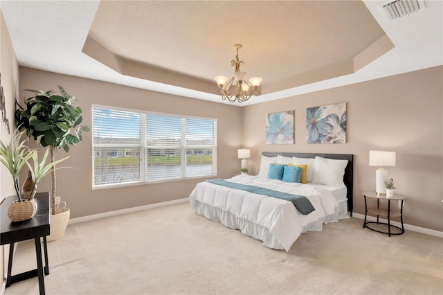 bedroom with visible vents, a raised ceiling, carpet, an inviting chandelier, and baseboards