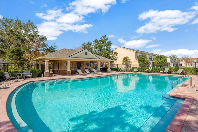 pool featuring fence and a patio area