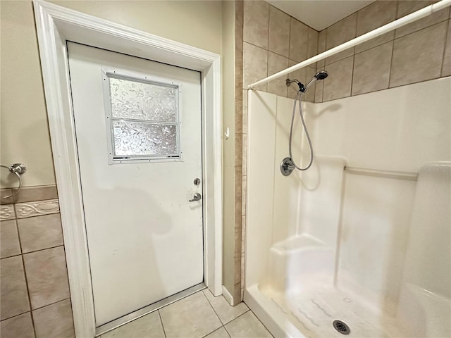 full bath with a stall shower and tile patterned floors