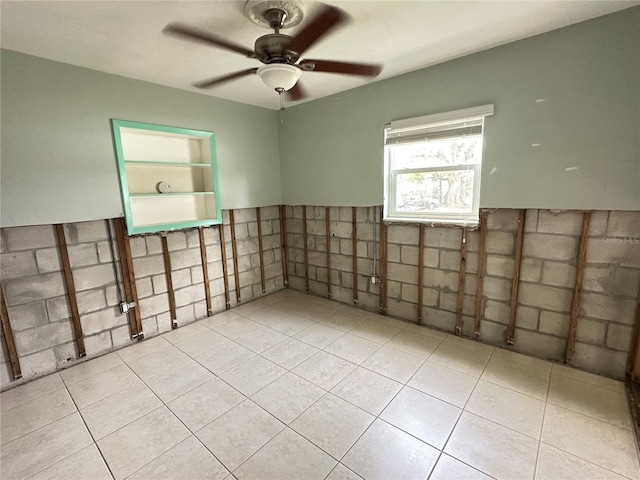 empty room featuring ceiling fan and light tile patterned flooring