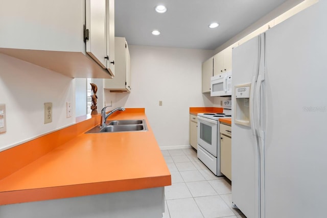 kitchen featuring light tile patterned floors, white appliances, a sink, white cabinetry, and light countertops