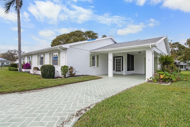 single story home featuring stucco siding and a front yard