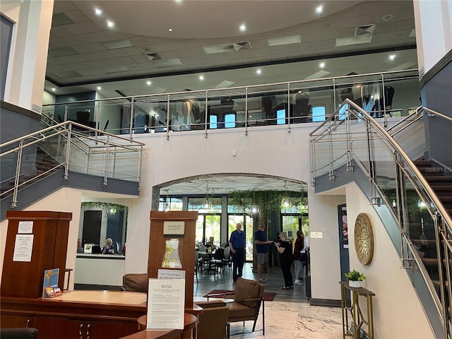 building lobby featuring visible vents and stairs