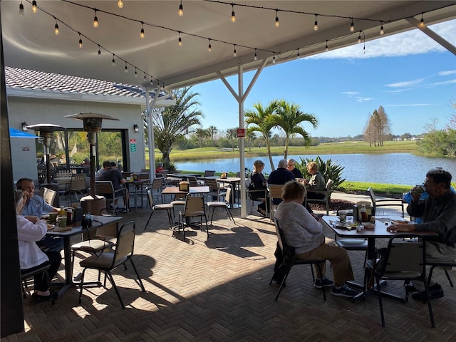 view of patio featuring outdoor dining area and a water view