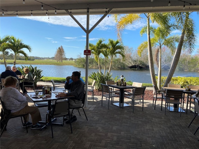 view of patio / terrace with outdoor dining space and a water view