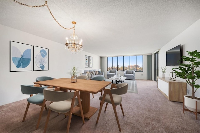 dining space with light carpet, an inviting chandelier, a wall of windows, and a textured ceiling