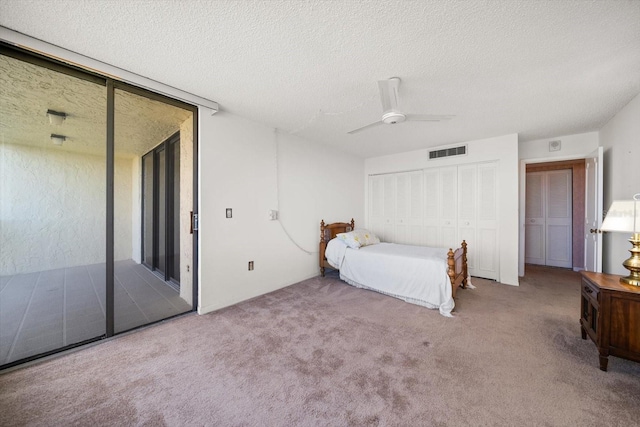 unfurnished bedroom with access to exterior, carpet, visible vents, and ceiling fan