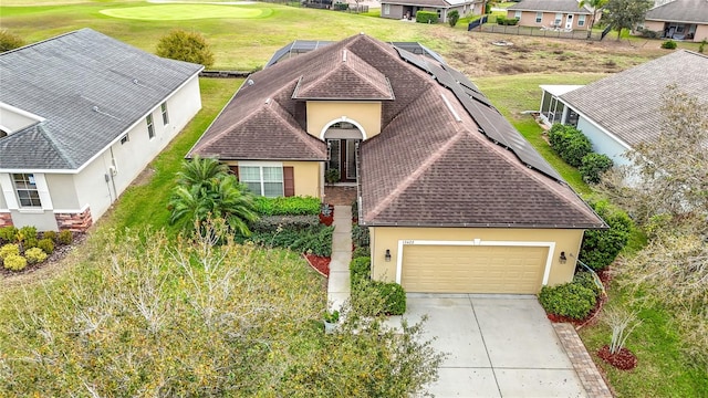 view of front of property featuring a garage, a shingled roof, concrete driveway, stucco siding, and golf course view