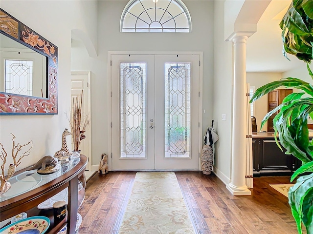 entryway with french doors, wood-type flooring, and ornate columns