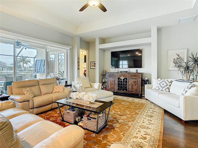 living area with ceiling fan and wood finished floors