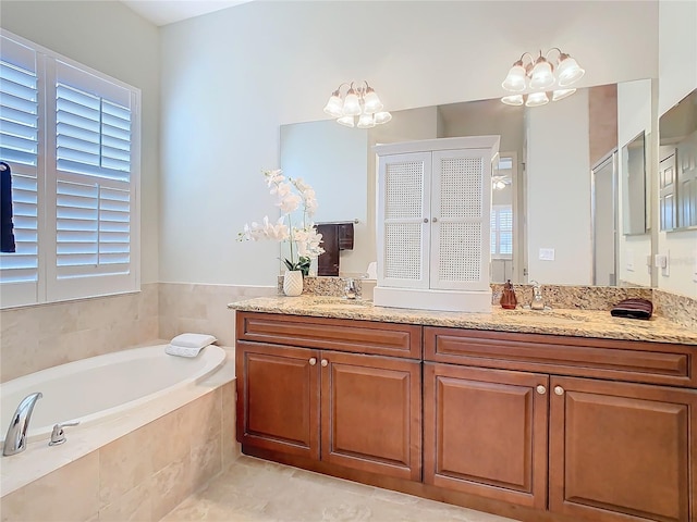 bathroom featuring a garden tub and vanity